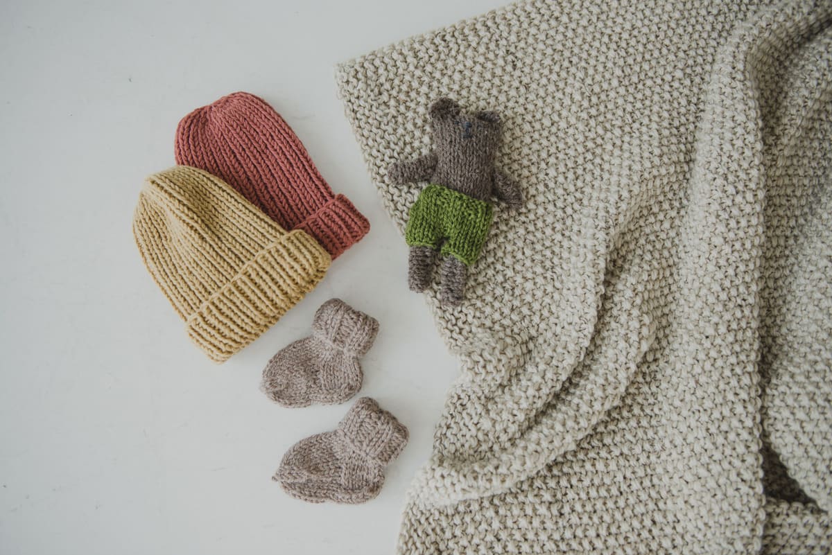 Knitted kids' toques and booties, ready to swap